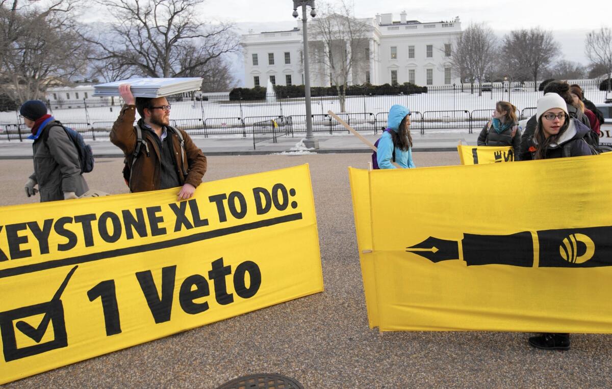 Opponents of the Keystone XL pipeline celebrate President Obama's veto outside the White House on Tuesday.