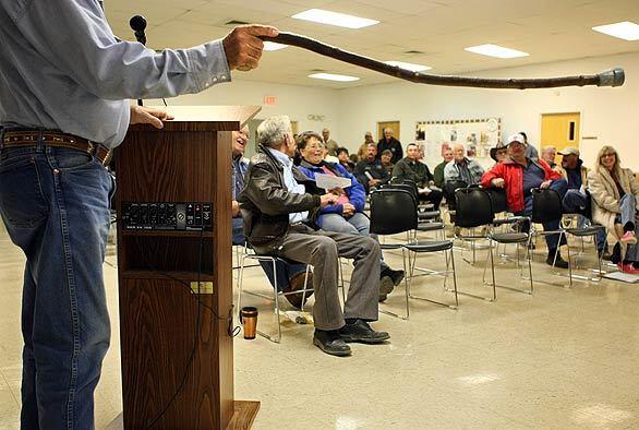 Gene McCall, 78, gestures with his cane