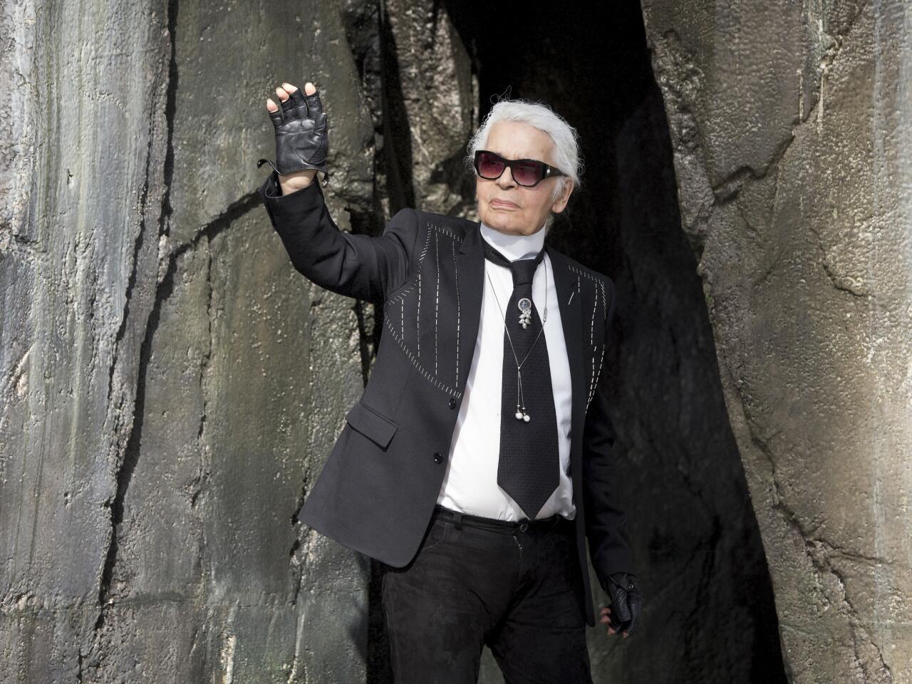 Karl Lagerfeld acknowledges the audience during the Chanel show as part of Paris Fashion Week in October 2018.