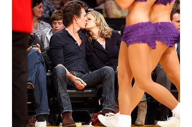 Actors Kevin Bacon and Kyra Sedgwick sneak a kiss as they take in Game 5 of the Western Conference semifinal series at Staples Center.