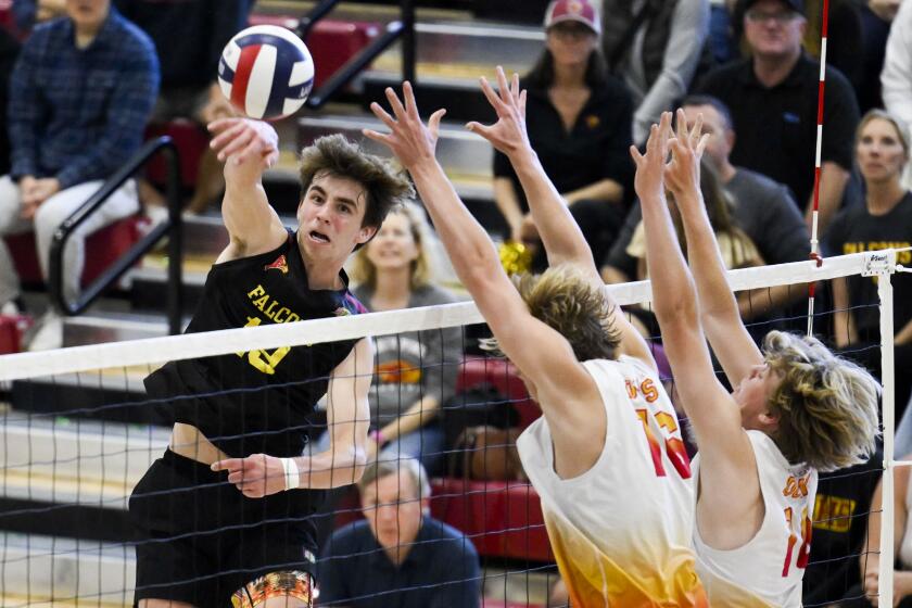 Torrey PinesO Christian Connell hits over Cathedral CatholicOs Easton Judson, center, and Tommy Branson during the CIF San Diego Section Open Division Boys Volleyball finals May, 11, 2024 in San Diego. (Photo by Denis Poroy)