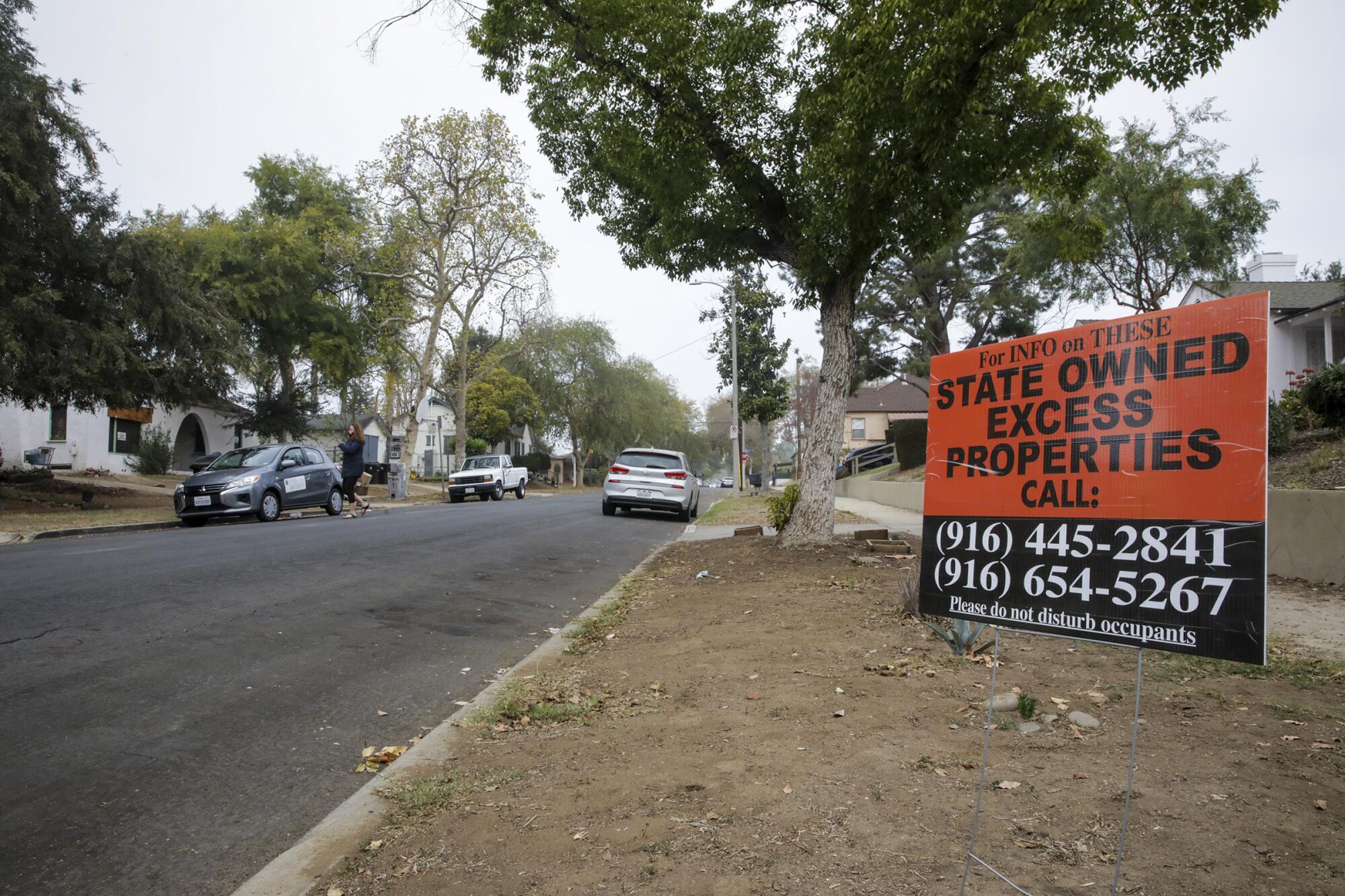A sign advertising "state owned excess properties" is seen in front of a home on Sheffield Avenue in El Sereno.