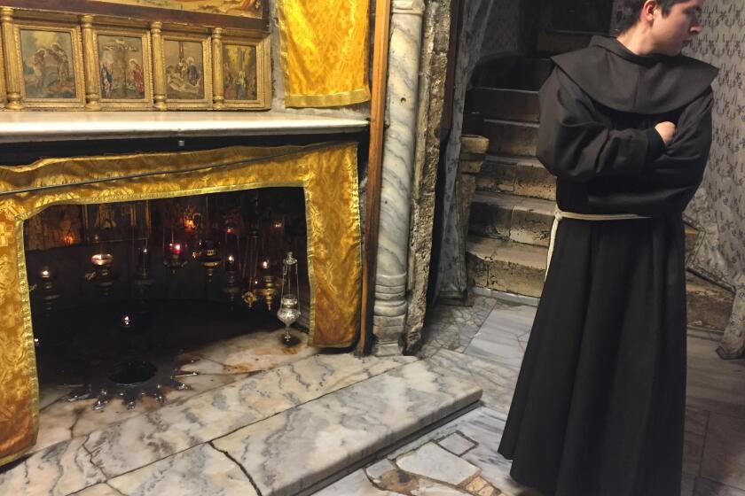 A Franciscan monk stands near the site where Jesus was born in the grotto inside Bethlehem's Church of the Nativity.