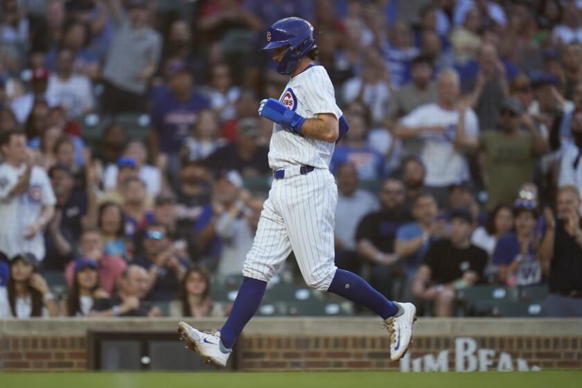 Chicago Cubs' Dansby Swanson scores on a passed ball by Atlanta Braves catcher Travis d'Arnaud during the second inning of a baseball game Tuesday, May 21, 2024, in Chicago. (AP Photo/Erin Hooley)