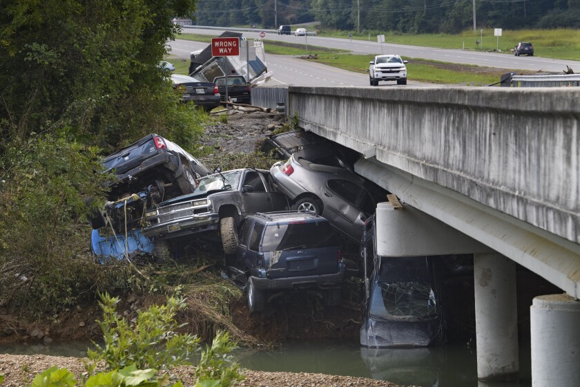 Cars are stacked on top of each other on the banks of Blue Creek