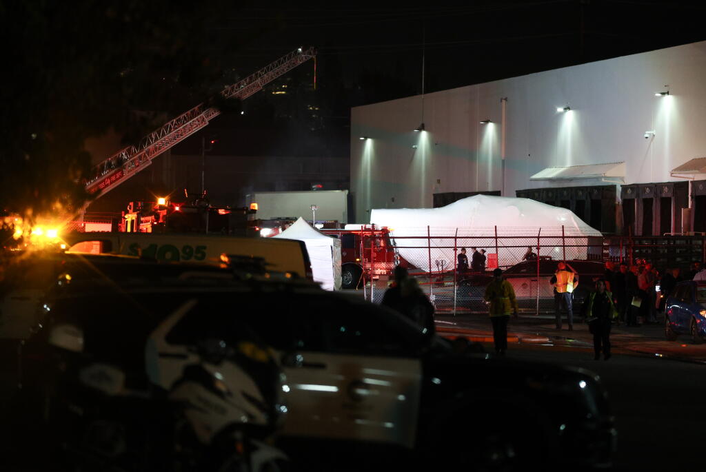 CHATSWORTH, CA - SEPTEMBER 15: Police and firefighters investigate the scene of a helicopter that crashed and burst into flames Tuesday night in Chatsworth not