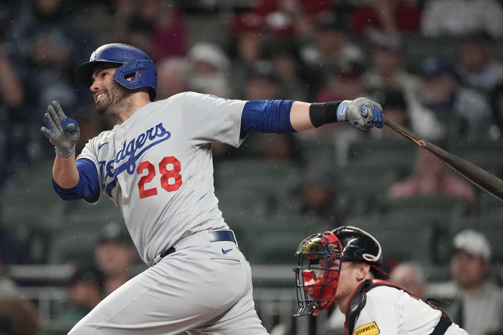 Dodgers designated hitter J.D. Martinez follows through on a single during the fourth inning.