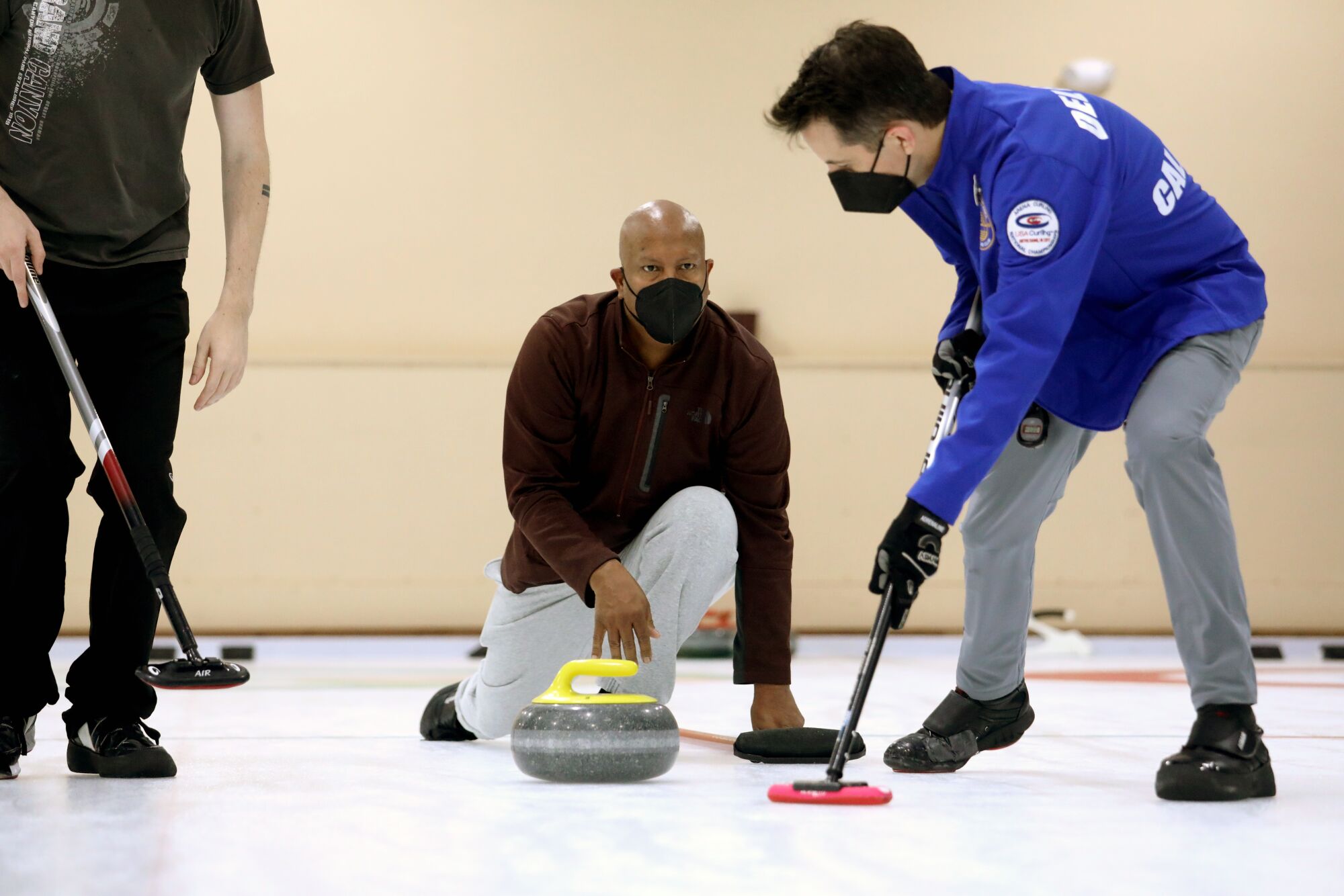Jose Sepulveda, 53, center, of San Francisco, who aspires to be on the Puerto Rico national curling team.