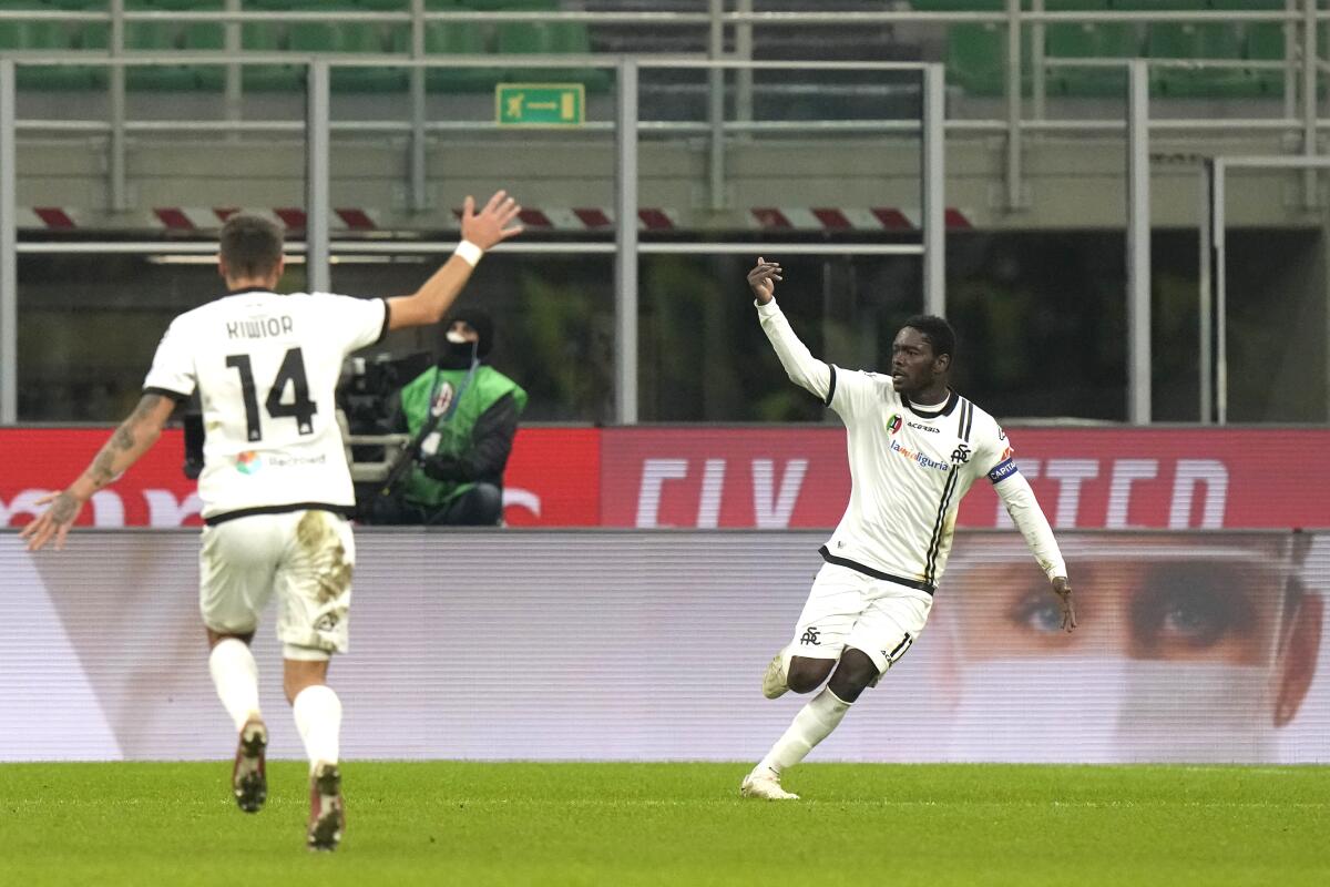 Spezia's Emmanuel Gyasi, right, celebrates his goal against Milan during a Serie A soccer match between AC Milan and Spezia, at the San Siro stadium in Milan, Italy, Monday, Jan.17, 2022. (AP Photo/Luca Bruno)