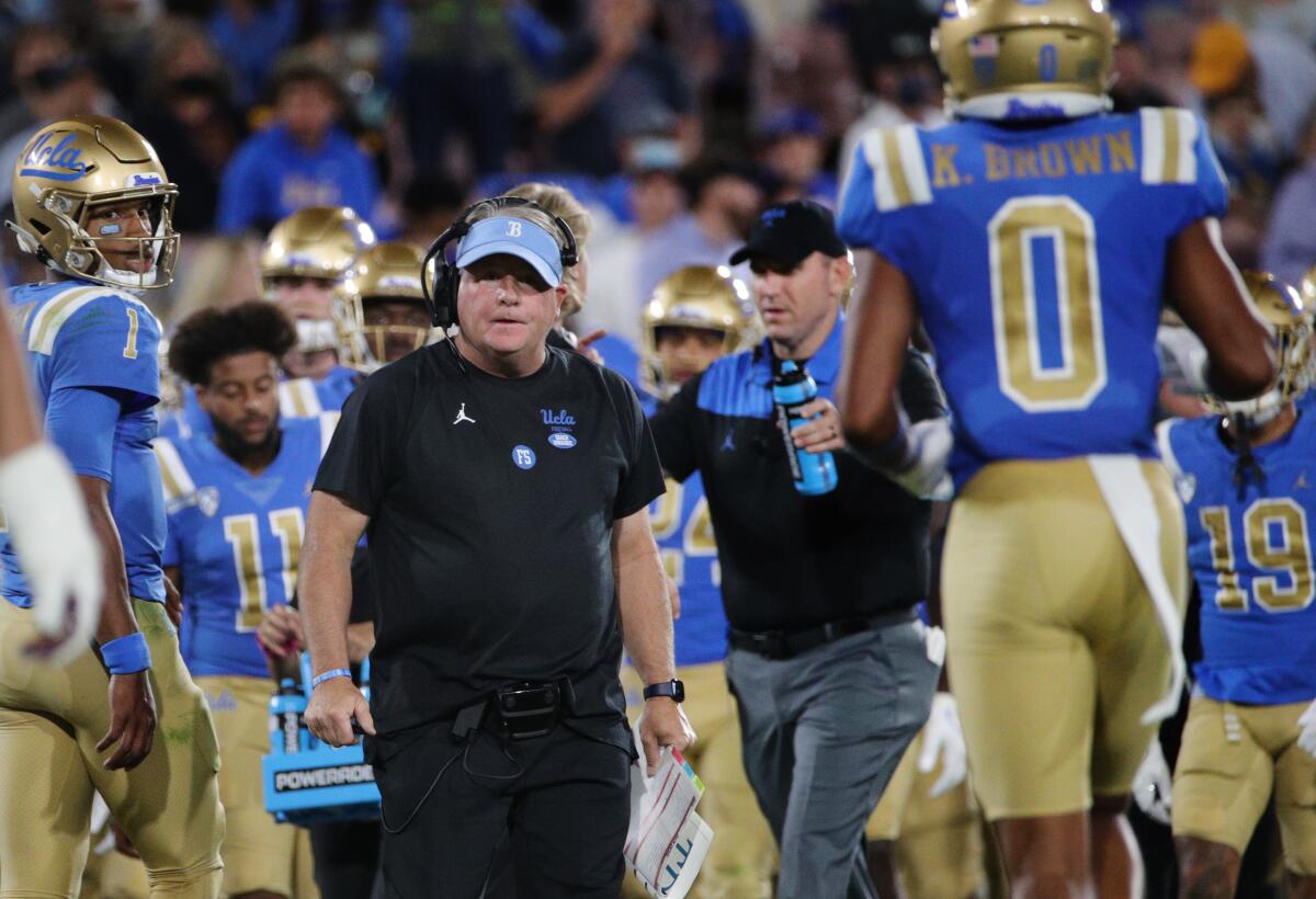 UCLA coach Chip Kelly stares at Bruins wide receiver Kam Brown