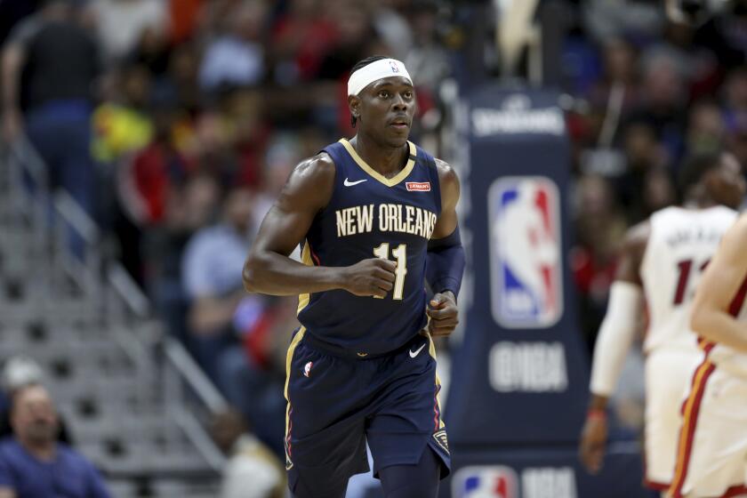 New Orleans Pelicans guard Jrue Holiday (11) runs up the court in the first half of an NBA basketball game against the Miami Heat in New Orleans, Friday, March 6, 2020. (AP Photo/Rusty Costanza)