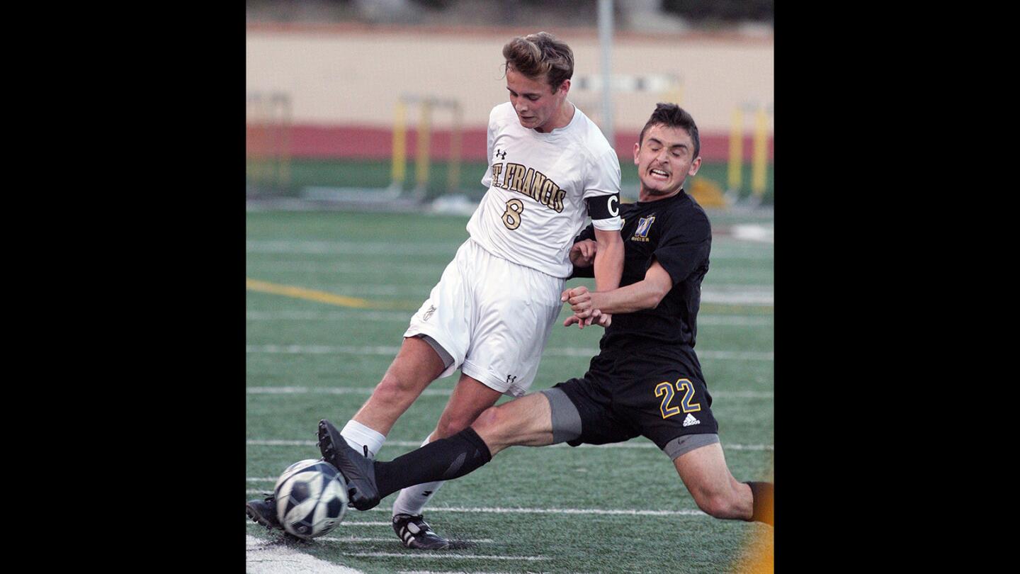 St. Francis' Liam Snashall gets the pass away just as Warren's Sergio Santana reaches him with a slide tackle in CIF Southern Section Division 1 second round soccer game at St. Francis High School on Wednesday, Feb. 24, 2016. St. Francis lost the game 4-1.