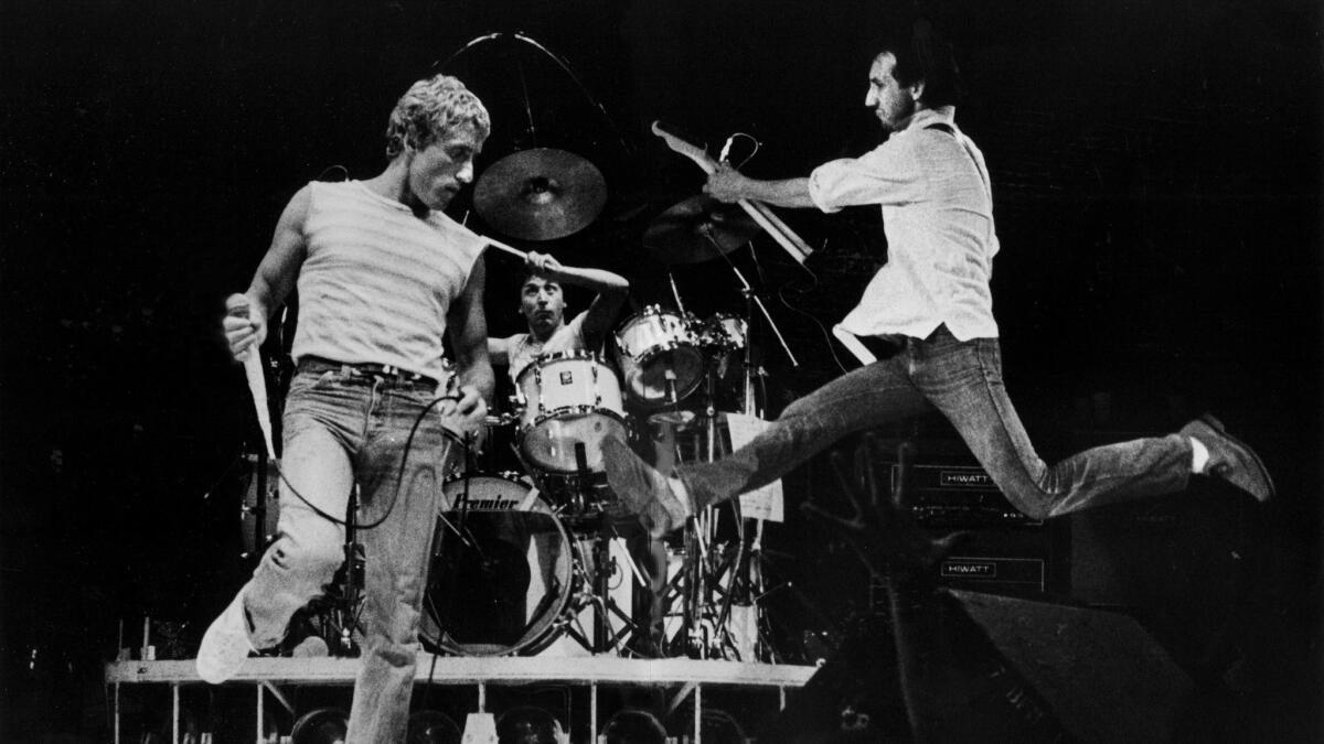 Pete Townshend, right, performs with Roger Daltrey, left, during a Los Angeles Sports Arena concert in 1980. Townshend typically ended the show by smashing his guitar.