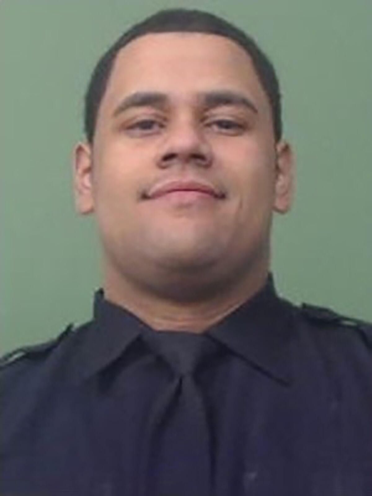 New York Police Department officer Wilbert Mora smiles while in uniform