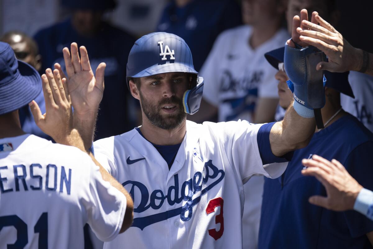 Chris Taylor celebrates with his Dodgers teammates after scoring on a double by Gavin Lux in the second inning.
