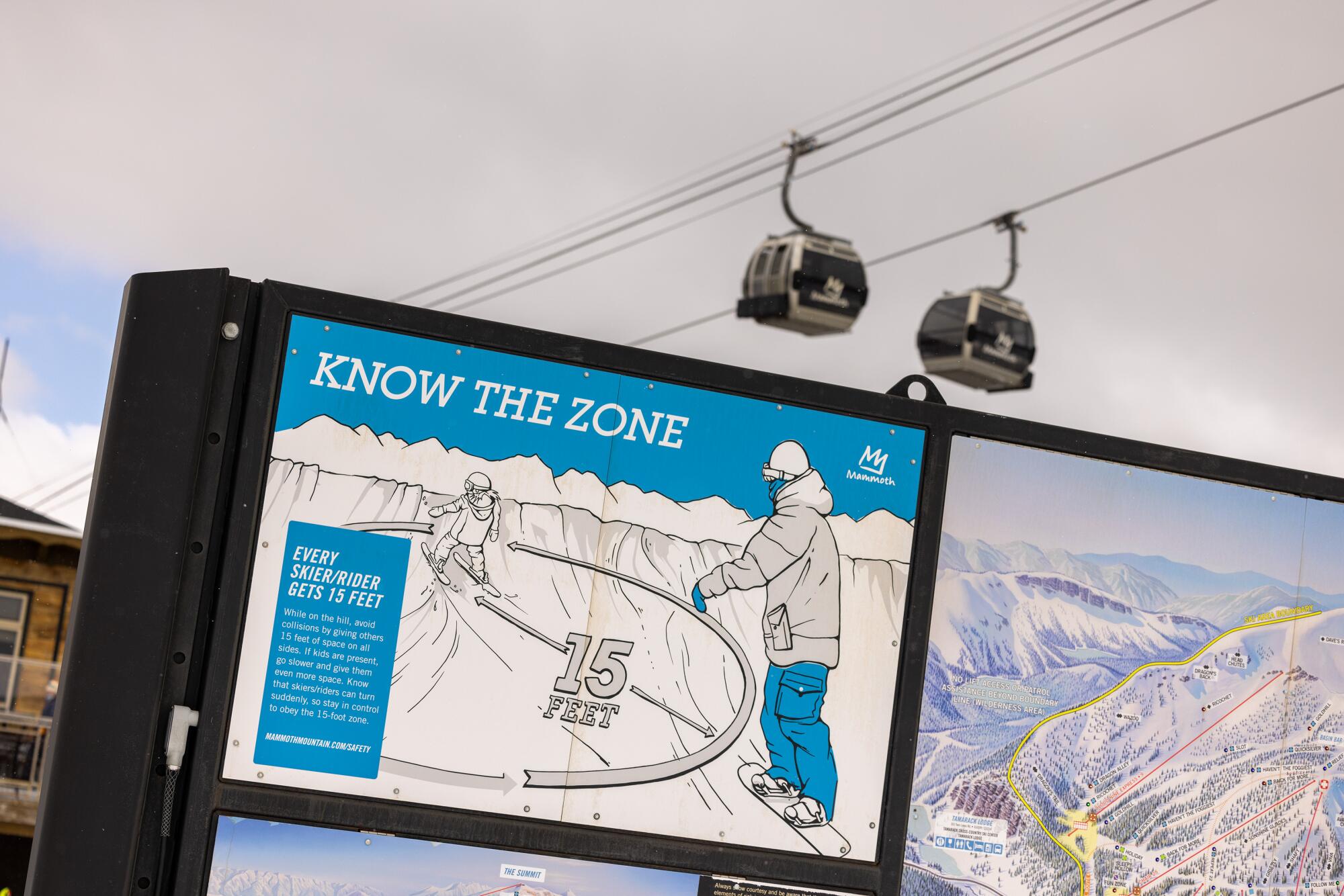 A sign asks skiers and snowboarders to stay at least 15 feet apart. 