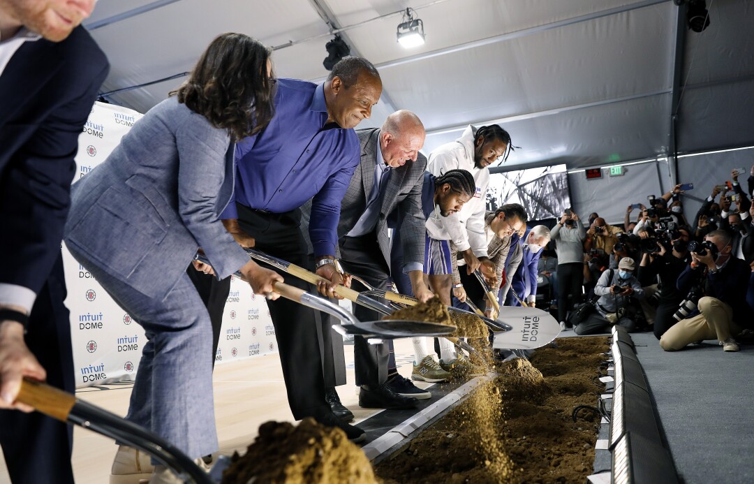 Clippers officials and dignitaries break ground with ceremonial shovels at the site of the team's new arena.