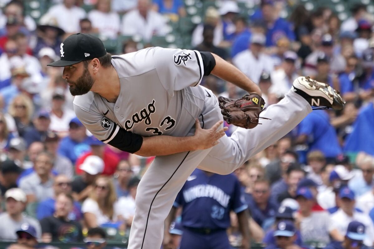 Chicago White Sox starting pitcher Lance Lynn follows through during the first inning of a baseball game against the against the Chicago Cubs, Friday, Aug. 6, 2021, in Chicago. (AP Photo/Charles Rex Arbogast)