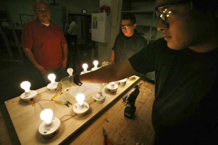 Instructor Jesus Hernandez, left, supervises students Juan Rodriguez, 18, right, and Andrew Araujo, 16, as they run through a check of an electrical system in his electrician class at Santee Construction Academy inside the Abram Friedman Occupational Center. One of Los Angeles Mayor Antonio Villaraigosa's partnership schools, the Santee Education Complex will be closing its academy dedicated to teaching construction and other skills aimed at aiding students to find occupations after high school.