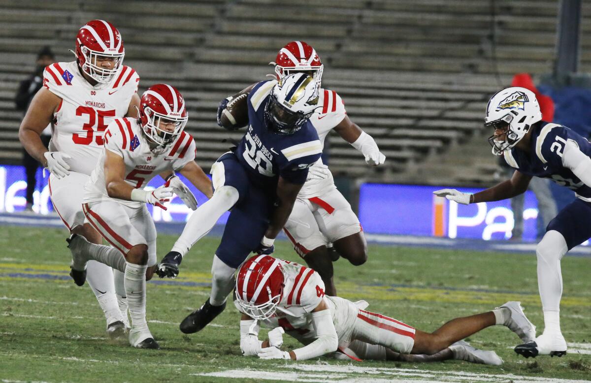 St. John Bosco running back Cameron Jones fights for yardage against Mater Dei defenders.