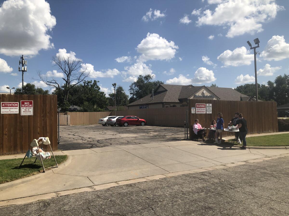 A small group of antiabortion protesters outside a parking lot