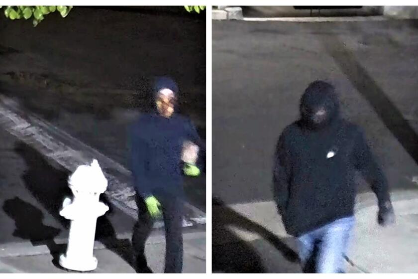 Two suspects seen on video March 13, 2022, are wanted by the FBI for allegedly tossing a Molotov cocktail at a health center.