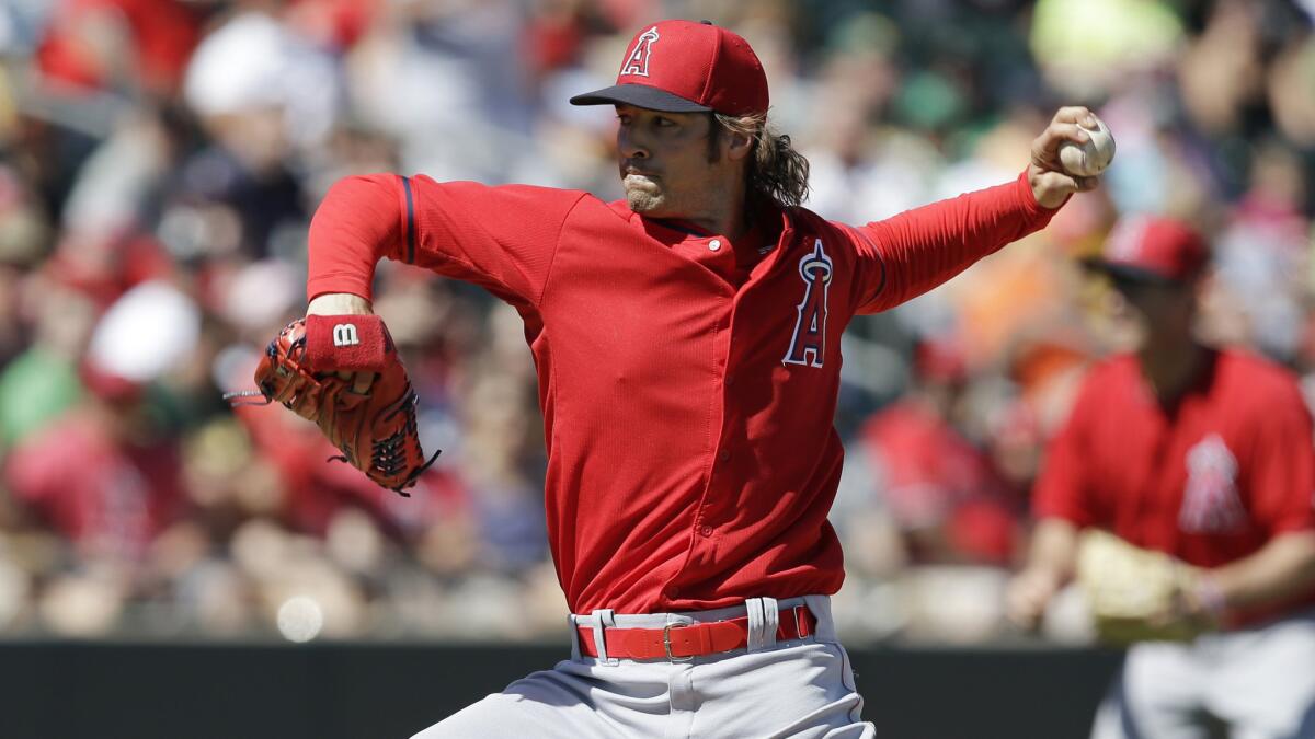 Angels starter C.J. Wilson delivers a pitch during an exhibition game against the Oakland Athletics on March 7.