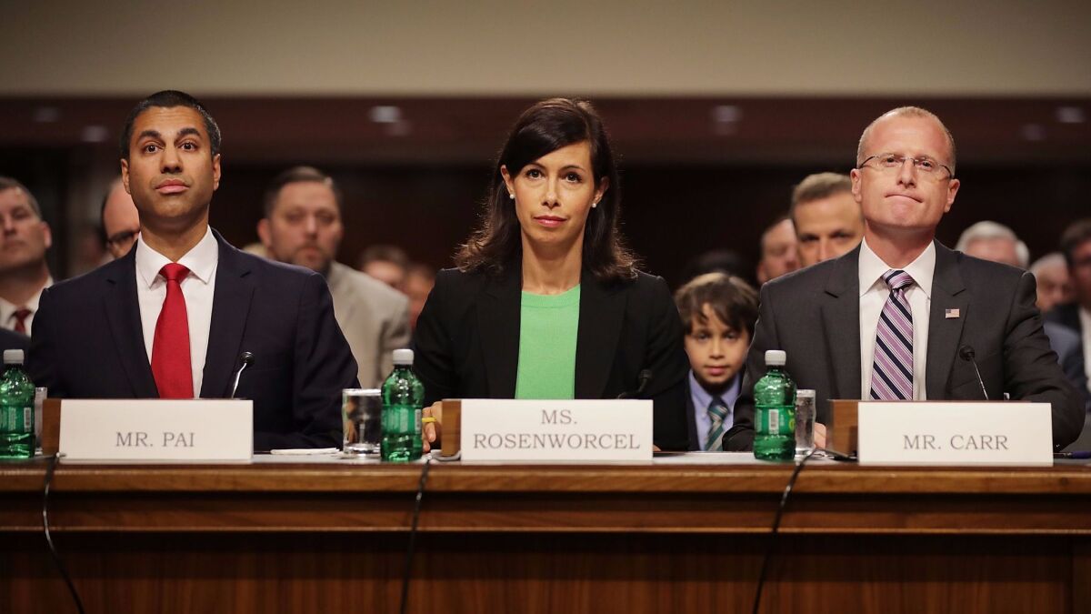 Jessica Rosenworcel sits with Ajit Pai, left, and Brendan Carr at a Senate confirmation hearing in July.