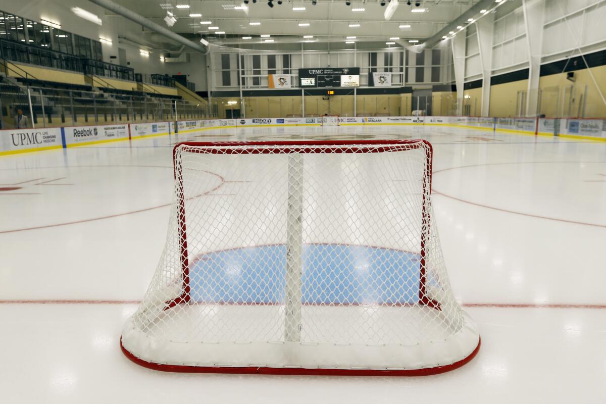 A hockey goal on the ice in a local public skating rink