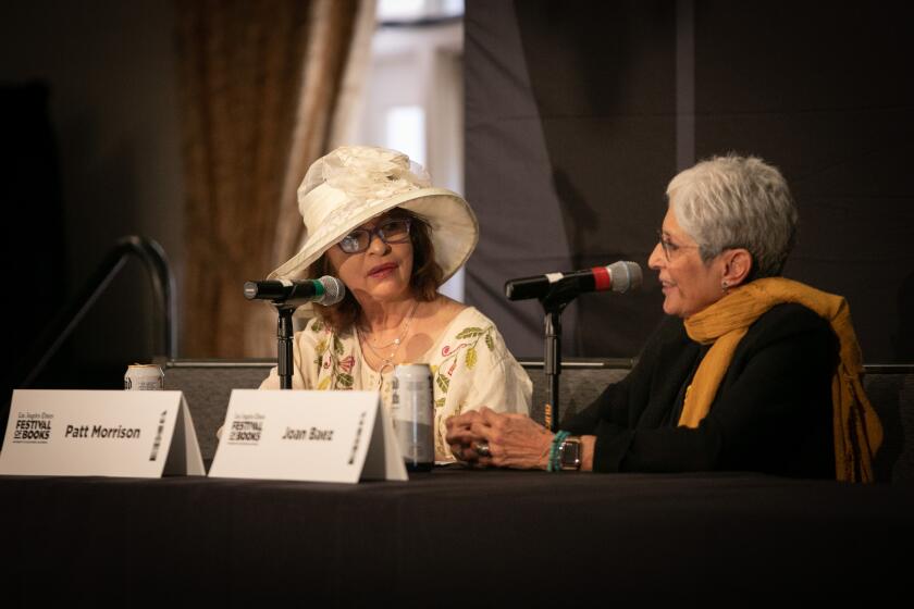 Two women sit in front of microphones at the Festival of Books.