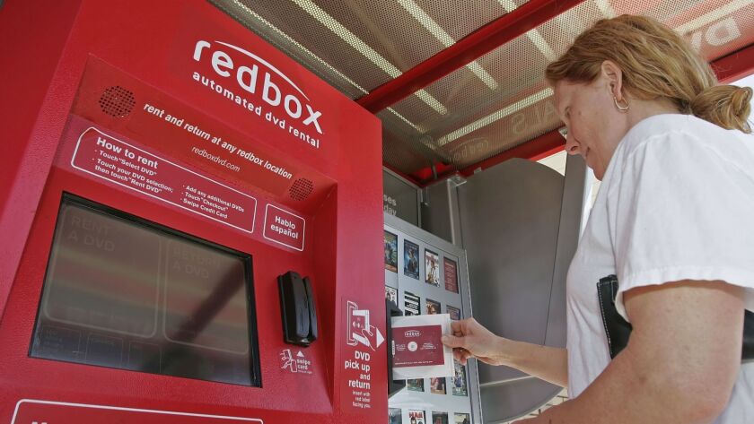 A customer returns a DVD movie to a Redbox rental kiosk in Provo, Utah. A U.S. district judge in Los Angeles has dealt a setback to Disney in the studio’s ongoing legal battle to stop Redbox from selling digital download codes.