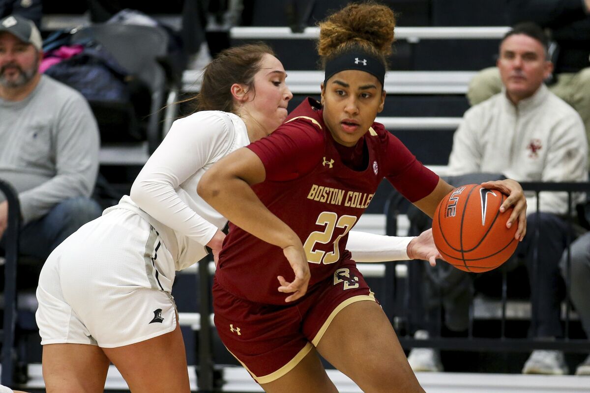 FILE - Boston College's Milan Bolden-Morris (23) avoids a steal attempt by Providence's Kyra Spiwak (5) during an NCAA women's basketball game on Nov. 17, 2019 in Providence, R.I. Bolden-Morris will be the first woman to become a football graduate assistant coach for a Power Five football program and in the Big Ten. Michigan announced her hire Tuesday, March 15, 2022. Bolden-Morris is a Florida native who played three seasons at Boston College before transferring as a graduate student to Georgetown. (AP Photo/Stew Milne, File)
