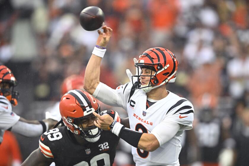 Cincinnati Bengals quarterback Joe Burrow (9) is hit by Cleveland Browns defensive end Za'Darius Smith (99) as he throws during the first half of an NFL football game Sunday, Sept. 10, 2023, in Cleveland. (AP Photo/David Richard)