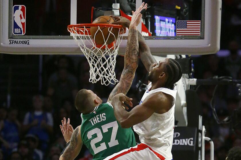LOS ANGELES, CALIF. - NOV. 20, 2019. Clippers forward Kawehi Leonard throws down a dunk against Celtics forward Daniel Theis in thje fourth quarter at Staples Center in Los Angeles on Wednesday might, Nov. 20, 2019. (Luis Sinco/Los Angeles Times)