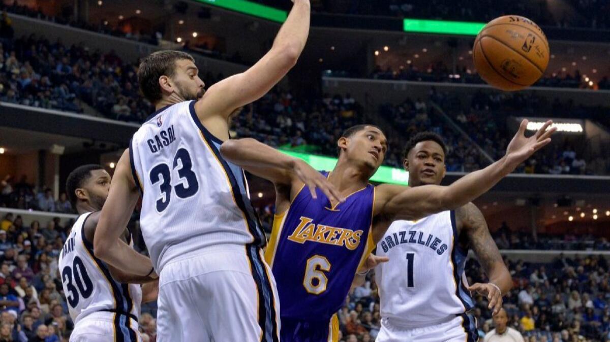 Lakers guard Jordan Clarkson struggles for control of the ball between Memphis guard Troy Daniels (30) and center Marc Gasol during a game on Dec. 3.