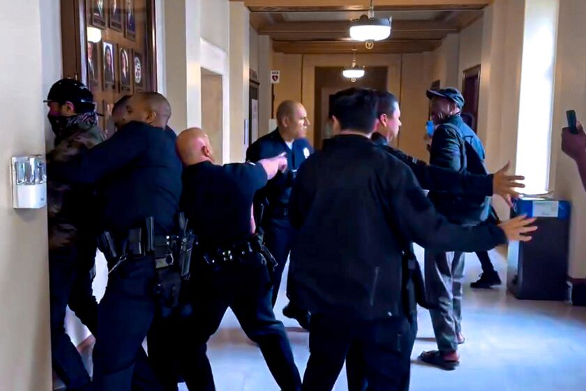 One arrested during Friday's L.A. City Council meeting. The arrest came after multiple protesters interrupted Councilmember Kevin de León's Cinco de Mayo presentation. (David Zahniser)
