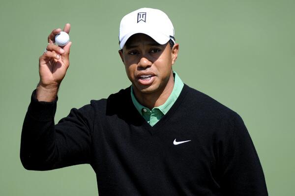 Tiger Woods waves his golf ball in the air after playing the second hole during the second round of the 2010 Masters Tournament at Augusta National Golf Club. (Photo by How/Getty Images)arry H