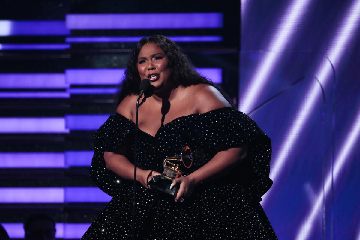 Lizzo accepts the award for solo pop performance at Sunday night's Grammys.