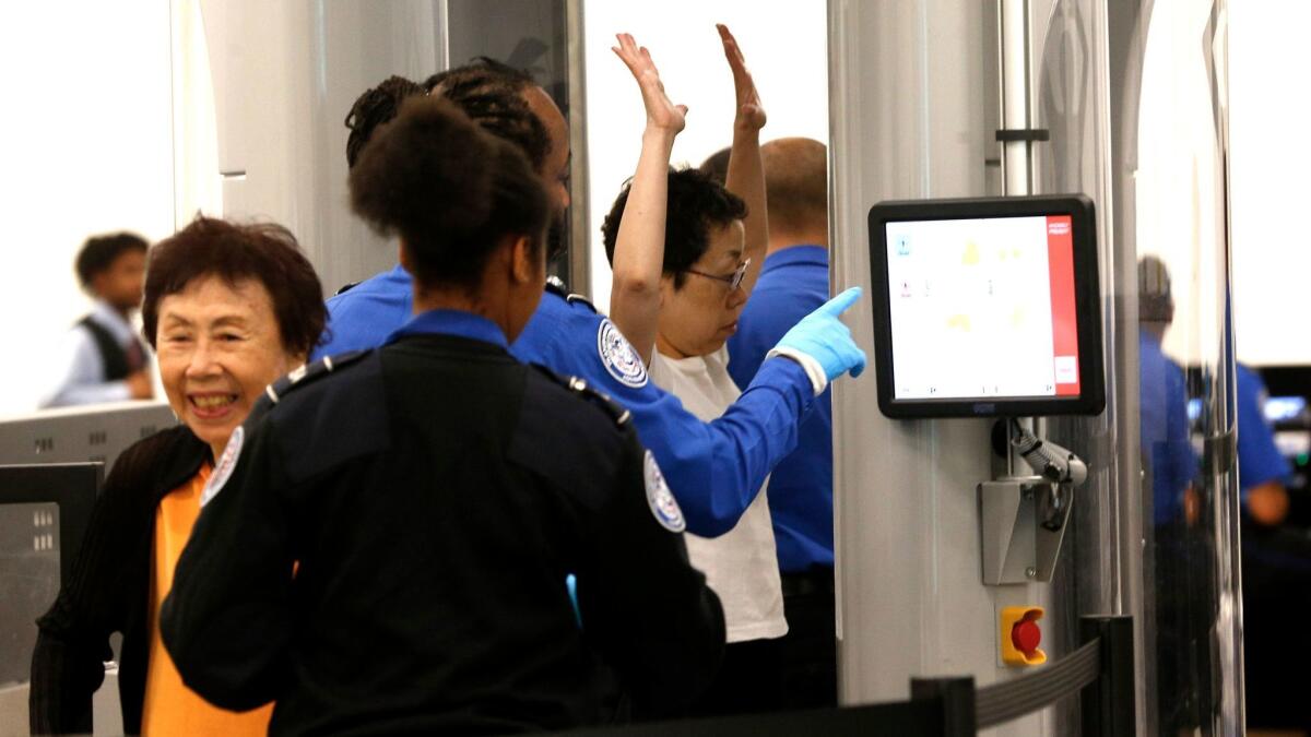 Passengers arriving from international flights pass through a Transportation Security Administration checkpoint at Los Angeles International Airport on Sept. 29, 2016.