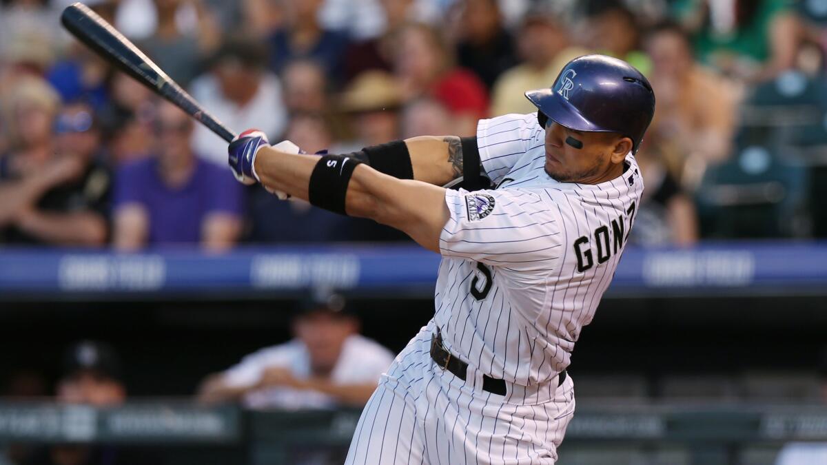 Colorado's Carlos Gonzalez strikes out while swinging against the Arizona Diamondbacks on Tuesday. Gonzalez left the game in the sixth inning with an injured finger.