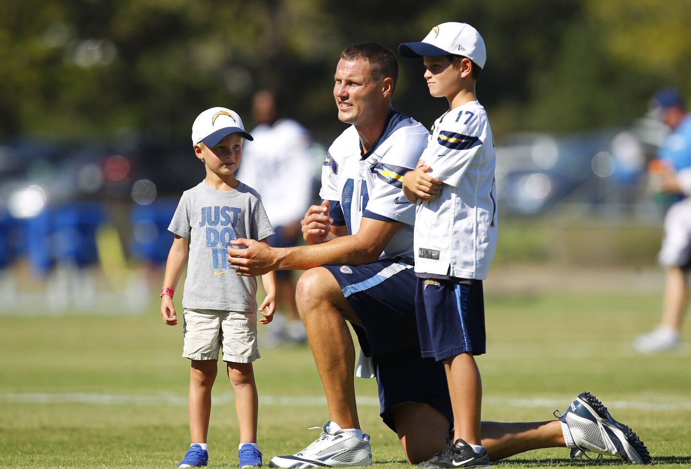 Chargere quarterback Philip Rivers looks on with his sons during a Chargers training camp practice on August 15, 2016.