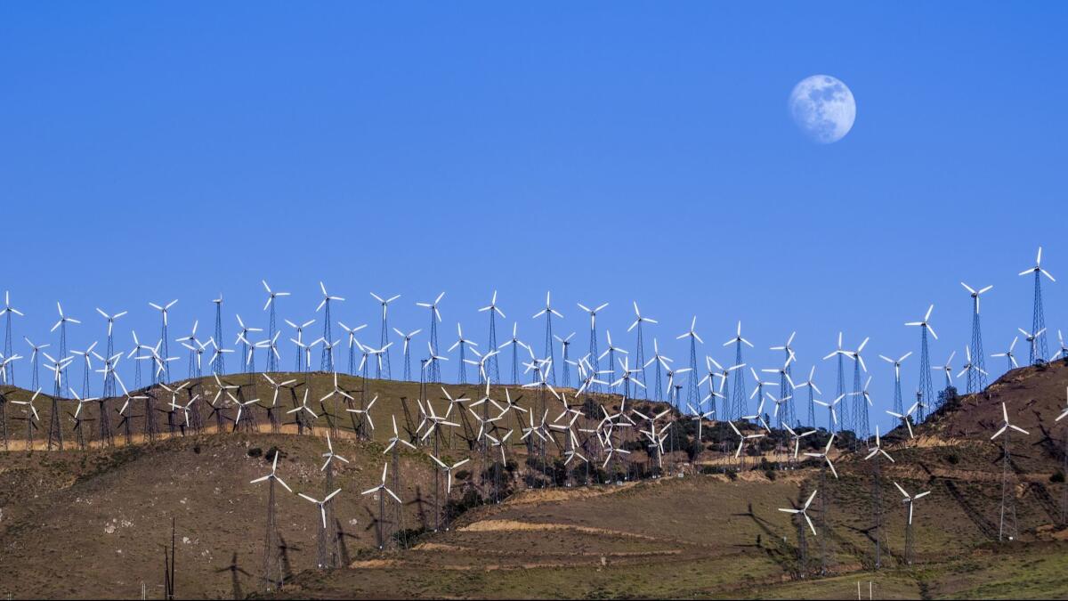 Turbines spin at a wind farm in Tehachapi, Calif.