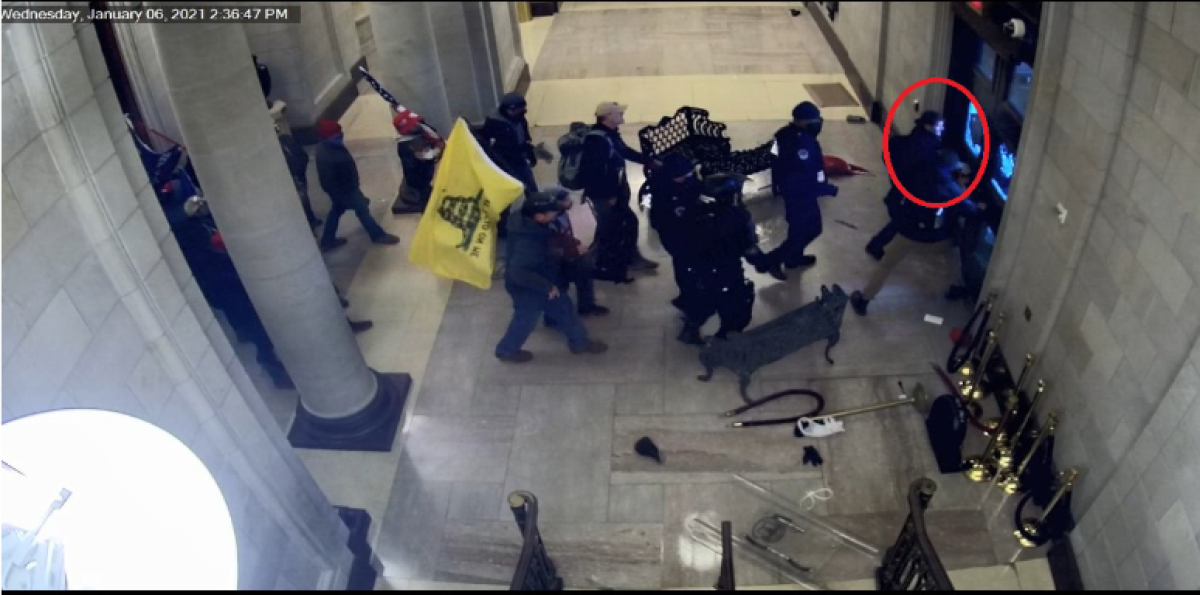 Jeffrey "Alex" Smith, circled, at the head of a group of rioters inside the Rotunda opening the east doors