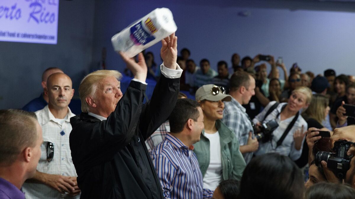 President Trump tosses paper towels into a crowd while visiting Guaynabo, Puerto Rico, in the aftermath of Hurricane Maria on Oct. 3, 2017.