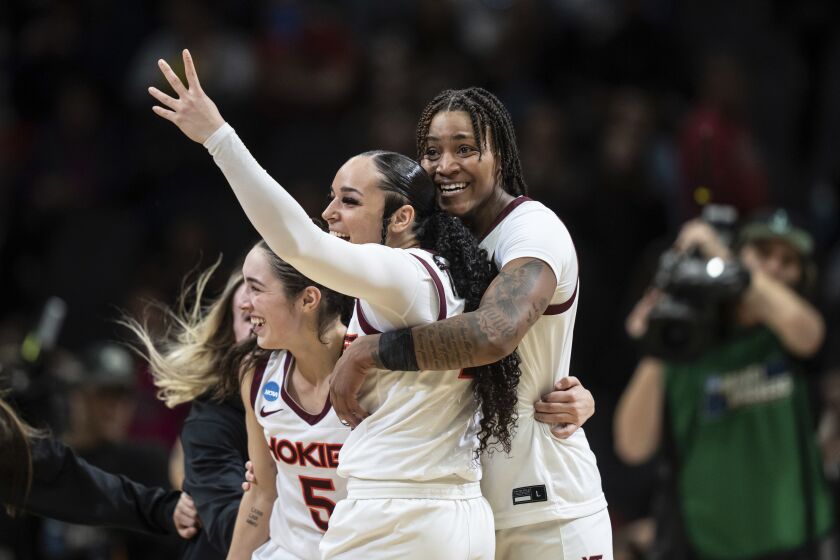 Virginia Tech players, from left to right, guard Georgia Amoore, guard Kayana Traylor and forward Taylor Soule celebrate after an Elite 8 college basketball game against Ohio State in the NCAA Tournament, Monday, March 27, 2023, in Seattle. (AP Photo/Stephen Brashear)