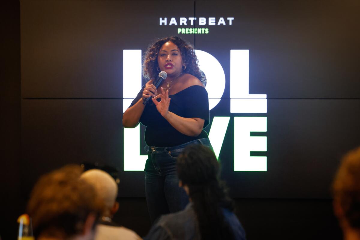 Black female comedian performing on stage at Hartbeat studios