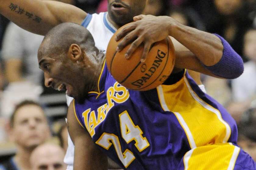 Guard Kobe Bryant tries to drive past then-Timberwolves guard Wayne Ellington, who signed Monday to join the Lakers.