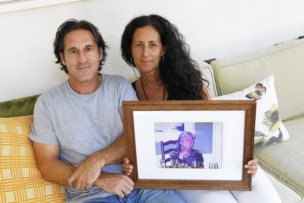 Gary Spivack and his sister Betsy Goodkin show a portrait of their mother, who died in her own home, as she wished.