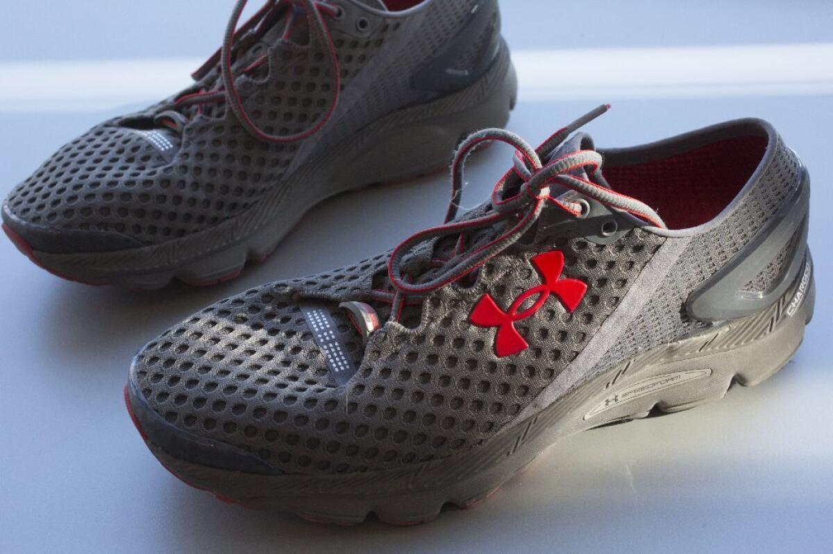 A pair of Under Armour SpeedForm Gemini 2 Record Equipped running shoes is displayed in New York. The shoes have an embedded chip to track exercise.