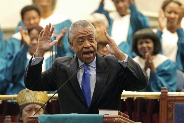 As members of the choir applaud, the Rev. Al Sharpton asks for a national day of prayer for Houston during regular Sunday services at Second Baptist Church in Los Angeles.